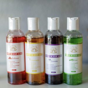 A group of four bottles of different colored liquid.