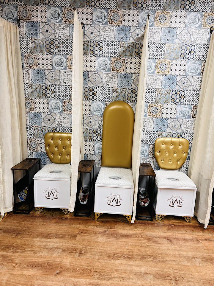 A row of chairs with gold seats and white walls.