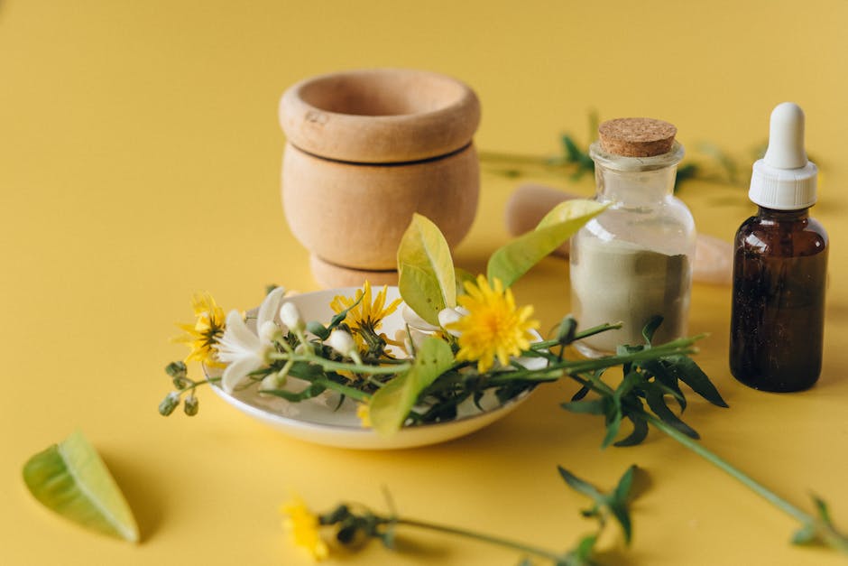 A yellow table with flowers and a mortar