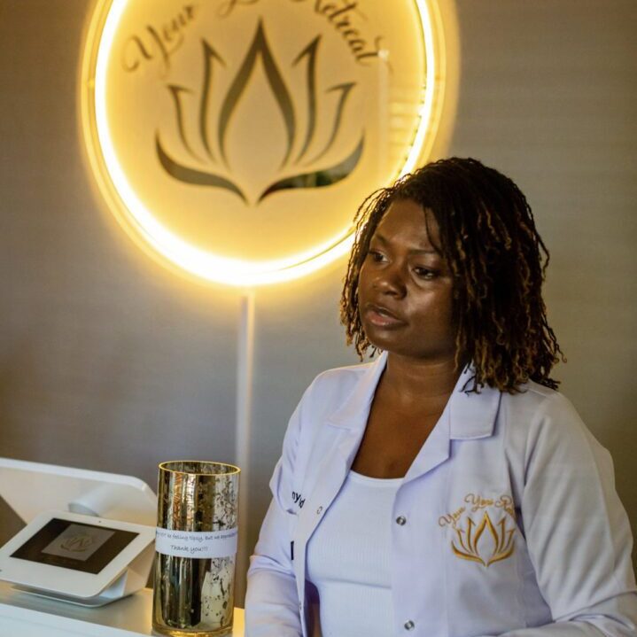 A woman sitting at the counter of a spa.